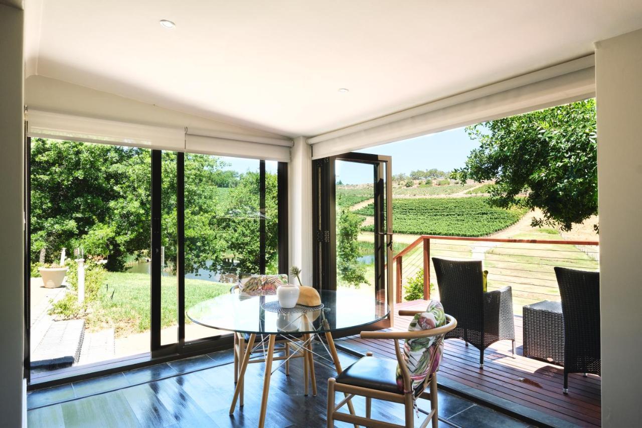 Alluvia Boutique Winery & Luxury Accommodation Stellenbosch Exterior foto A room with a view of the vineyards